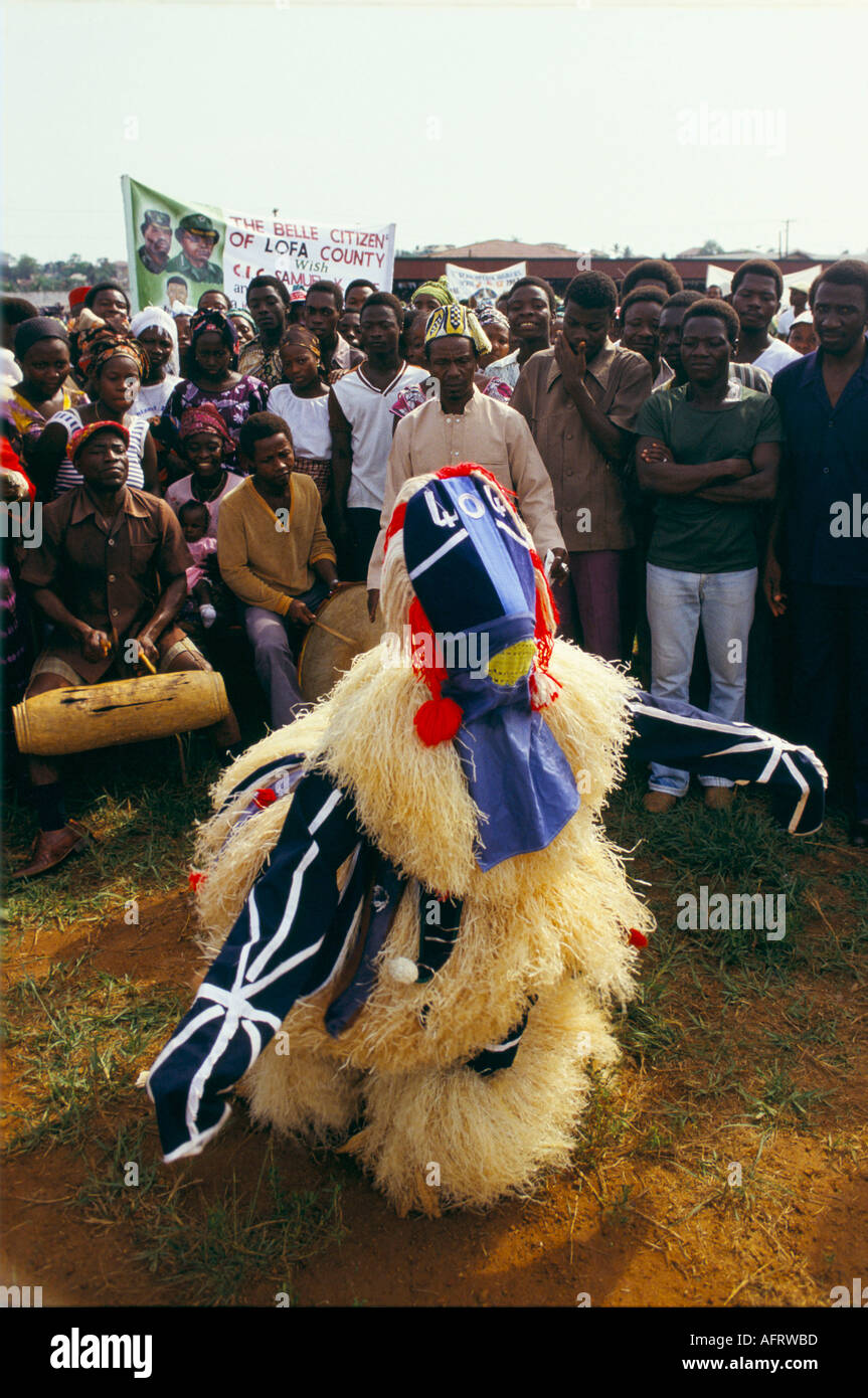 Liberia, Monrovia, National Redemption Day celebrations annually on 12th April. Traditional costumed figure dancing football stadium West Africa 1983 Stock Photo
