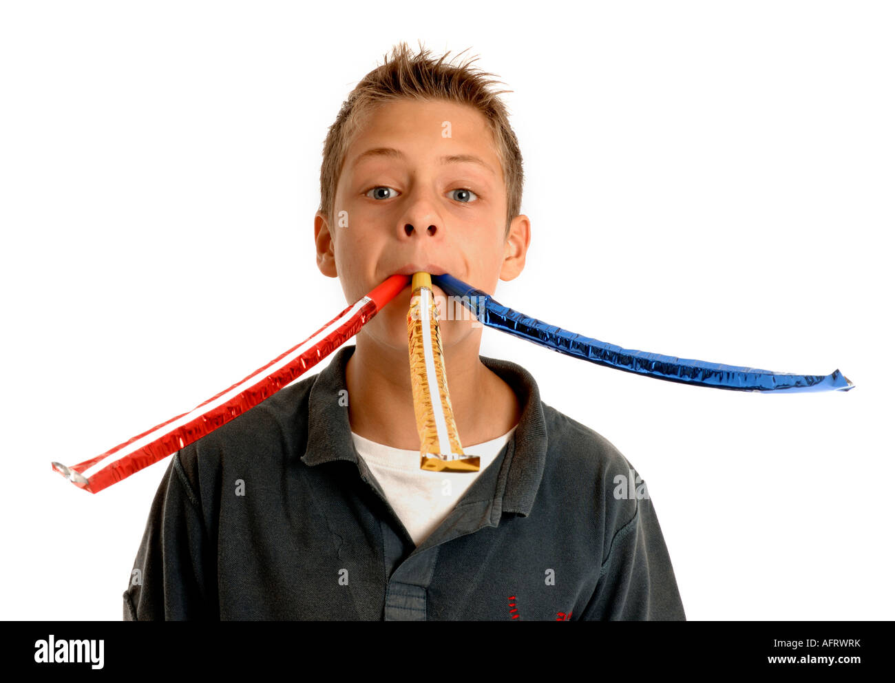 Boy blowing 3 party whistles Stock Photo