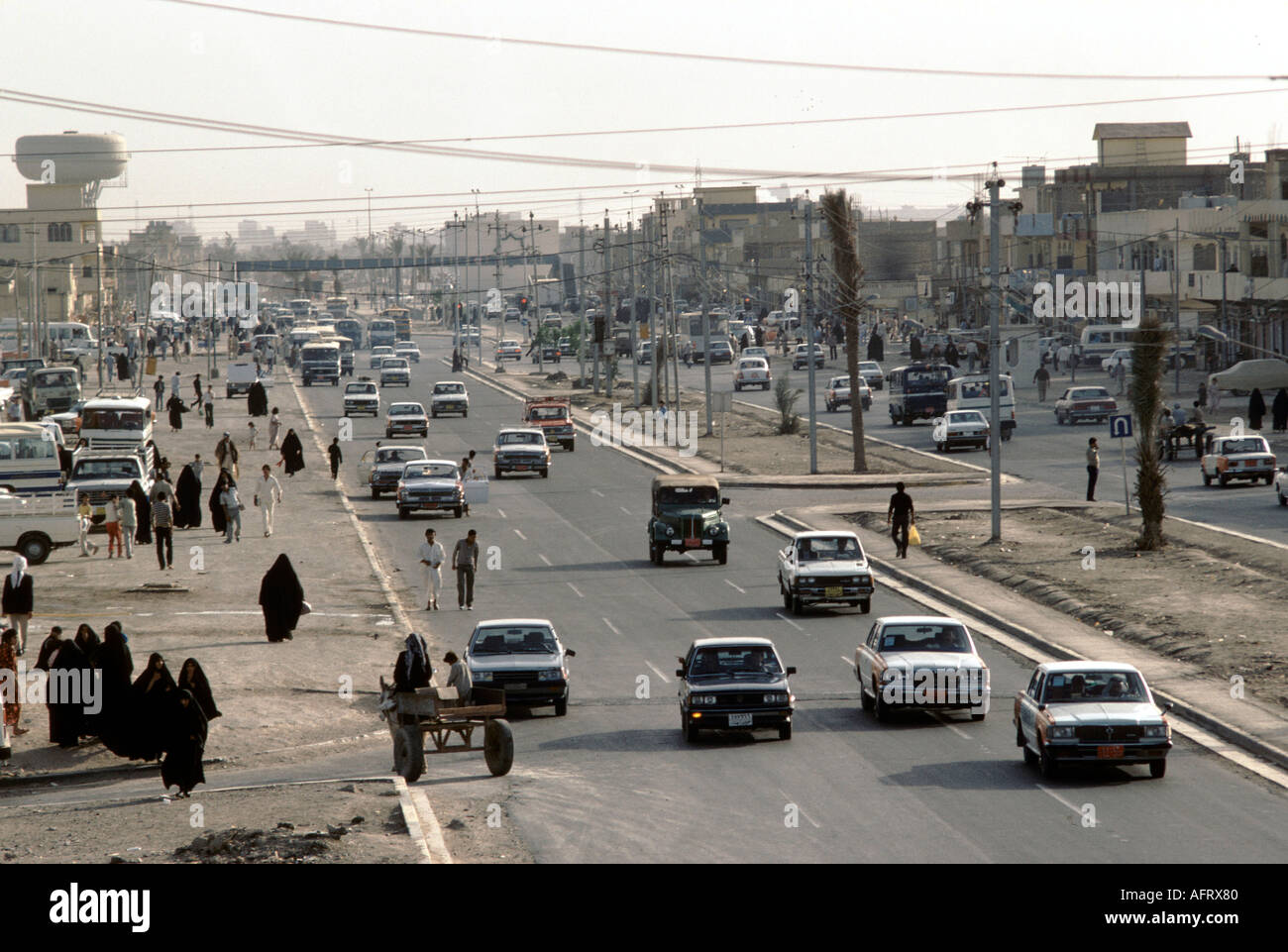 Iraq 1980s, Saddam City Baghdad.  English British Leyland buses traffic people going about their daily lives.  1984 HOMER SYKES Stock Photo