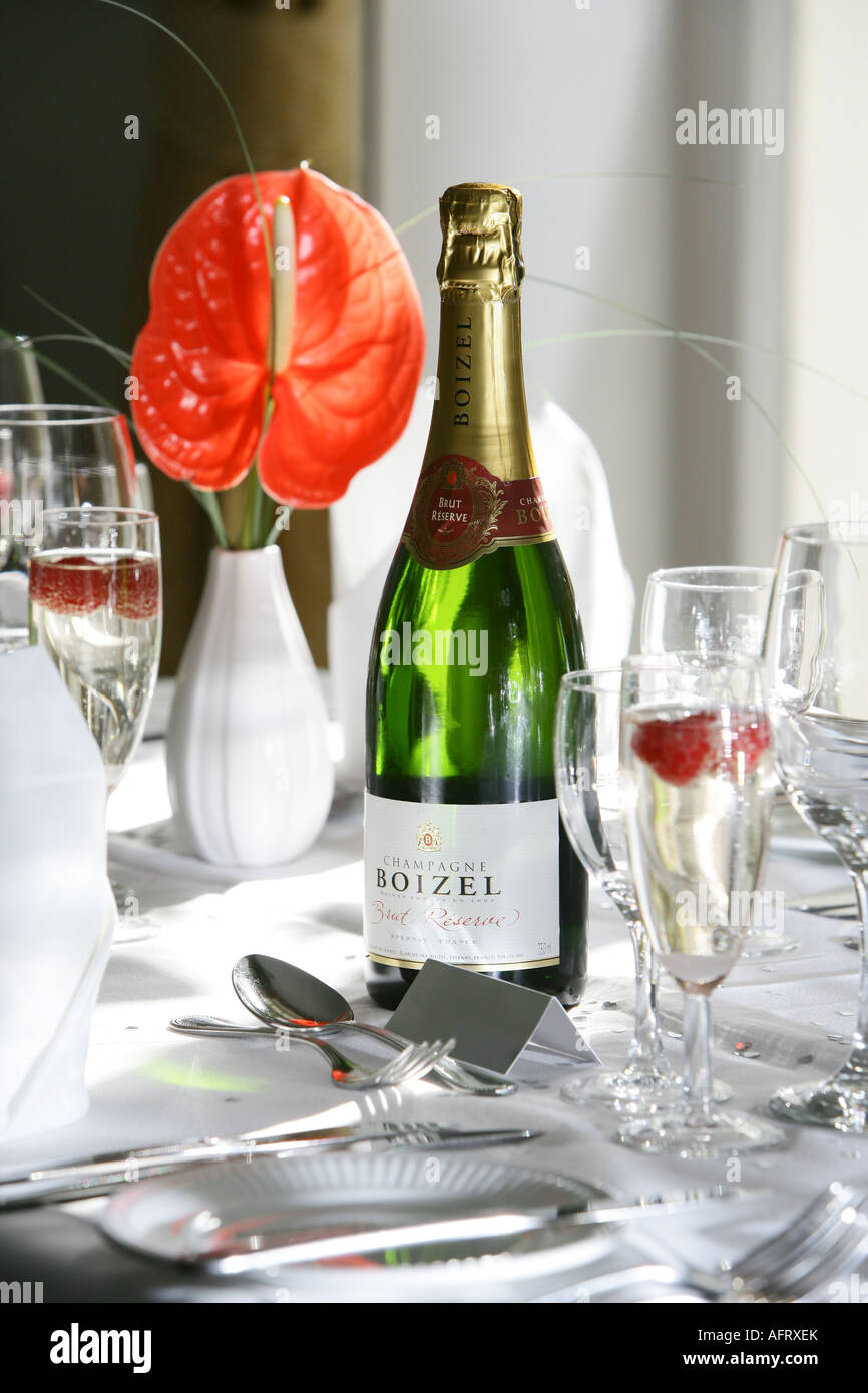 Champagne bottle in table setting at wedding breakfast Stock Photo Alamy