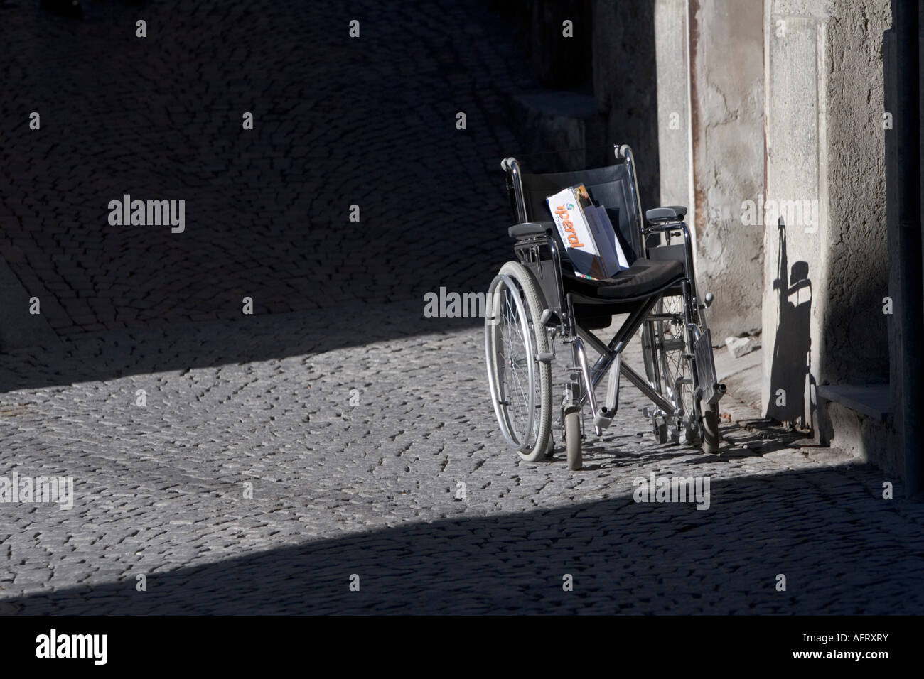 Wheelchair outside of shop with no disabled access. Bormio, Italy Stock