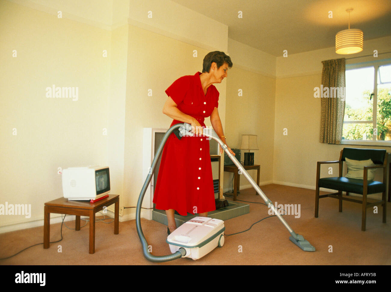 Middle England Aged Woman Doing The Housewwork In Apartment