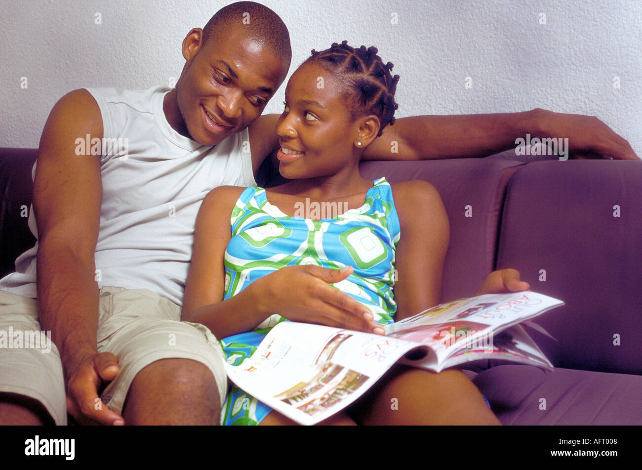 Black couple reading magazine Stock Photo - Alamy