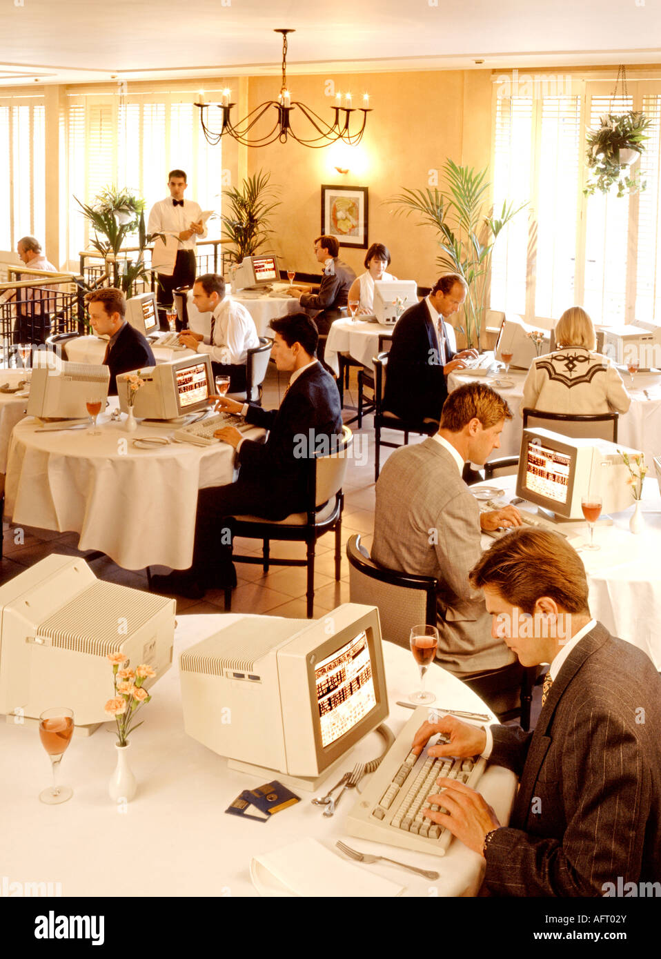 A WORKING LUNCH, OFFICE WORKERS HAVING A COMPUTER FOR LUNCH IN A RESTAURANT LUNCH BREAK Stock Photo