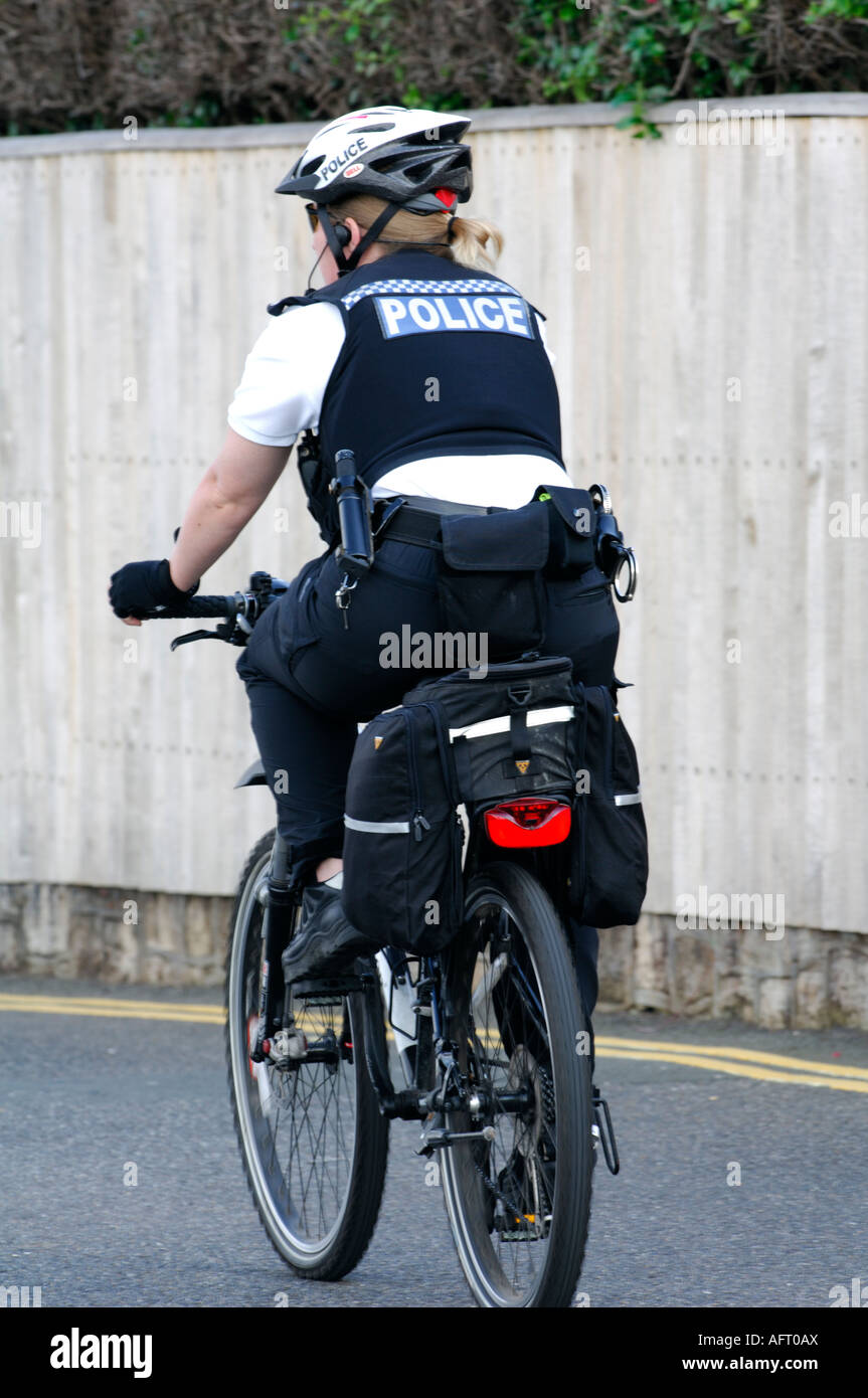 policewoman wpc on a cycle bicycle bike on the beat plod Stock Photo