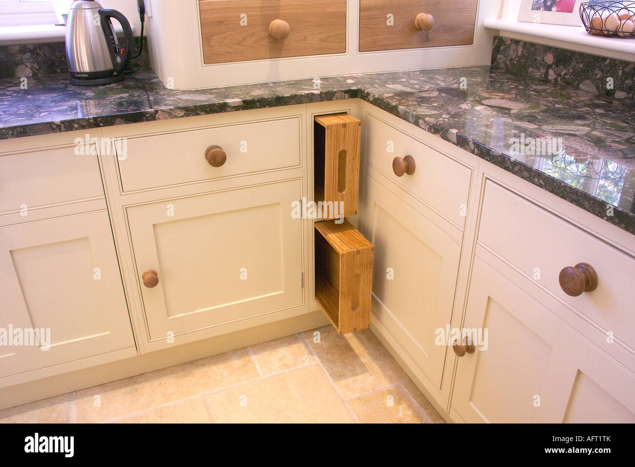 Wooden Trays Stored In Space Between Cream Kitchen Units With