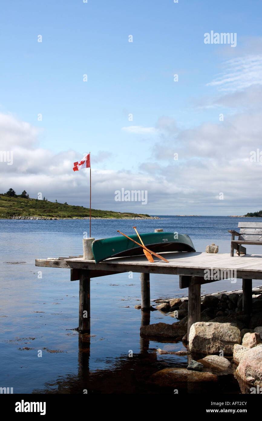 jetty with Adirondack bench and an upside down Old Town canoe, Nova