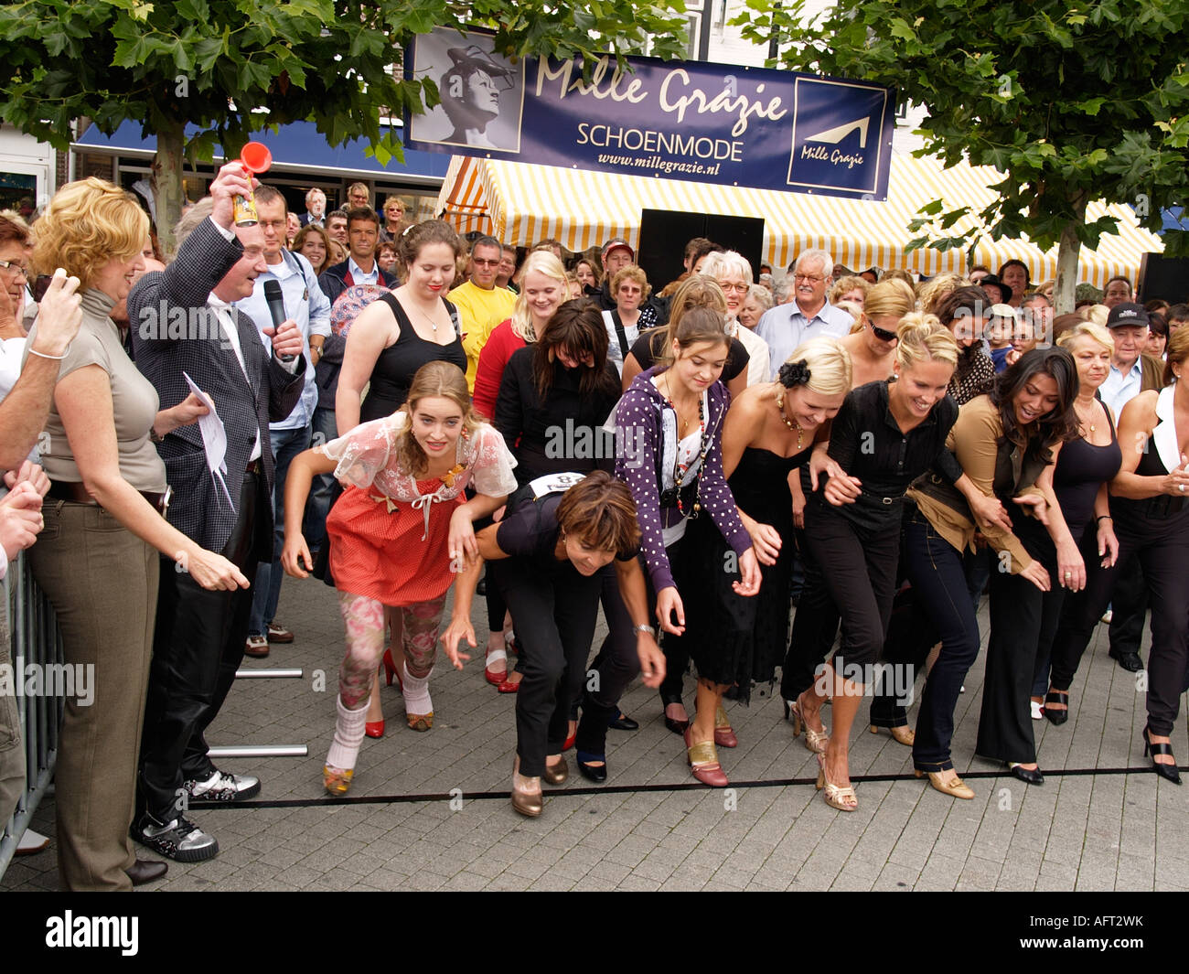 Start of a high heel with pretty girls competing and famous Dutch shoe designer Jan Janssen starting them Stock Photo - Alamy