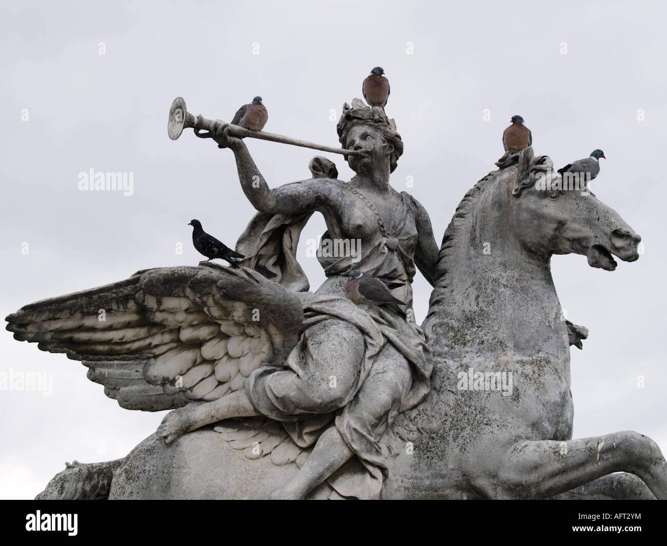 Doves pigeons sitting resting on a statue in the city of Paris France Stock Photo