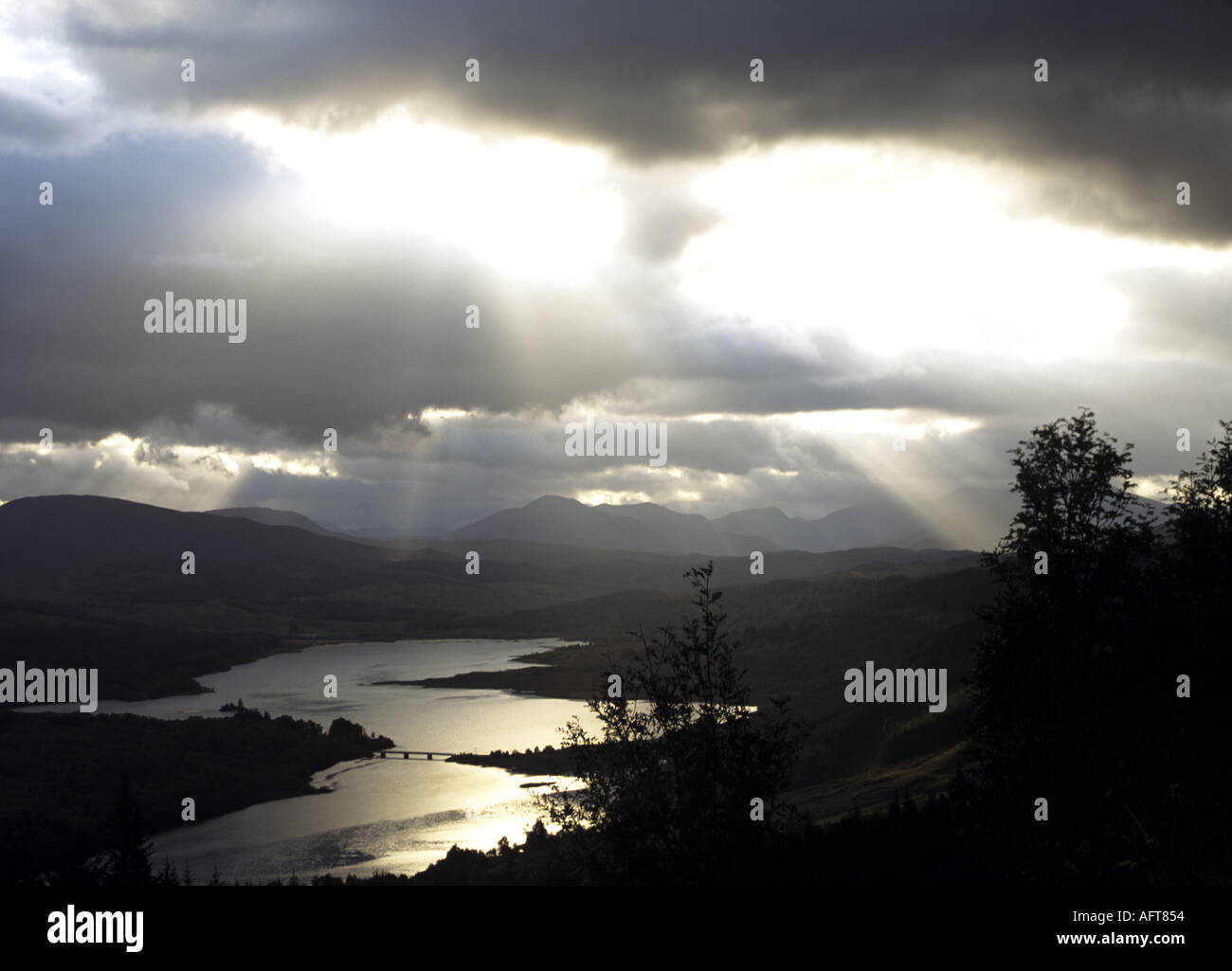 GLENGARRY SCOTTISH HIGHLANDS UK October sun rays peep through the heavy cloud on Loch Garry as seen from the Glengarry viewpoint Stock Photo