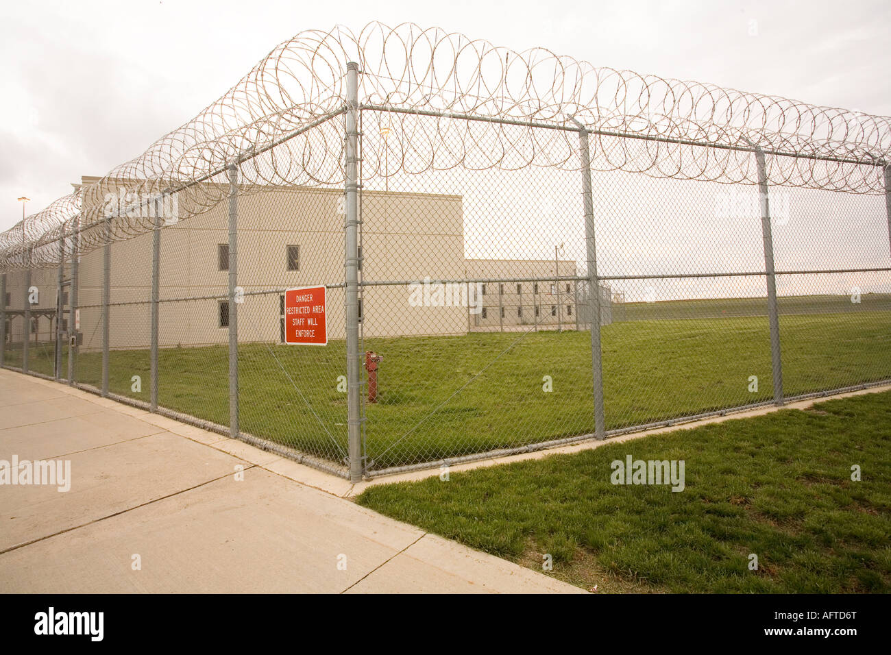 Housing unit and perimeter fence. Medium security housing unit inside prison. Maximum security prison, Nebraska, USA. Stock Photo