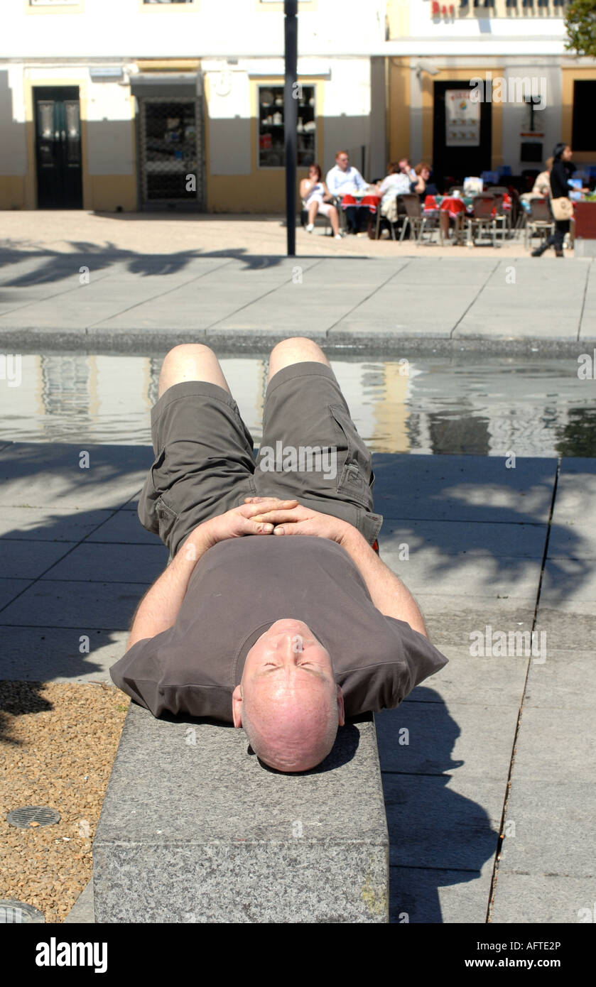 A man laid asleep in the sun Stock Photo - Alamy