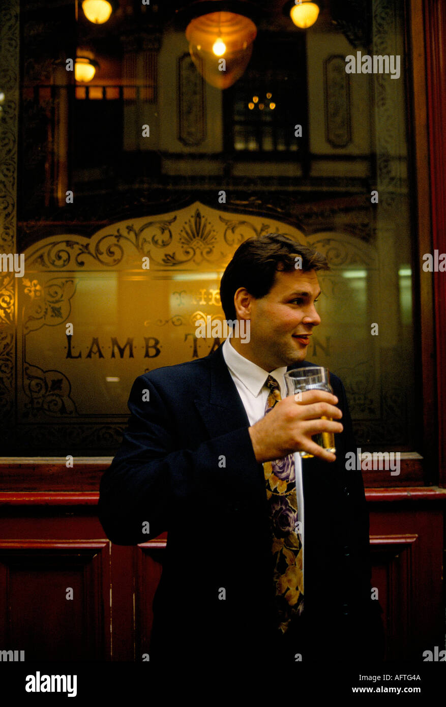City of London 1992, businessmen chatting over a lunch time drink outside the Lamb Tavern Leadenhall Market 1990s UK HOMER SYKES Stock Photo