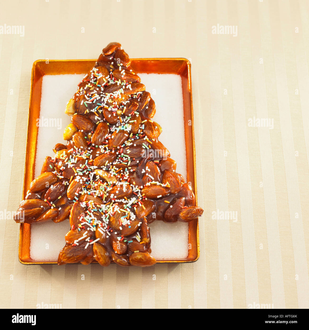 Christmas-tree-shaped almond cookie on tray, Close-up Stock Photo