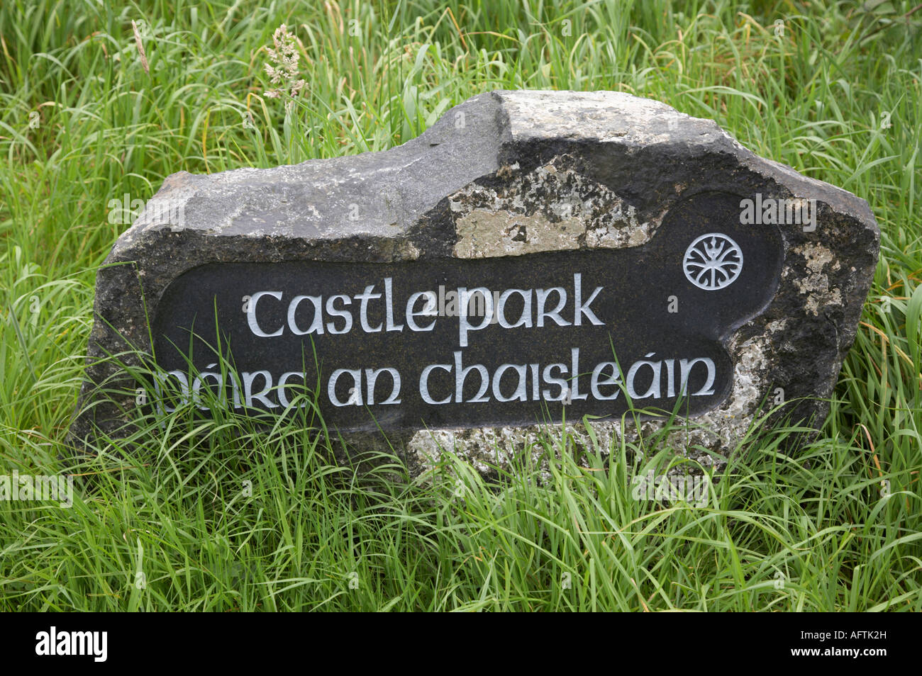 carved stone indicating castle park in english and irish on a route on the causeway coast northern ireland Stock Photo