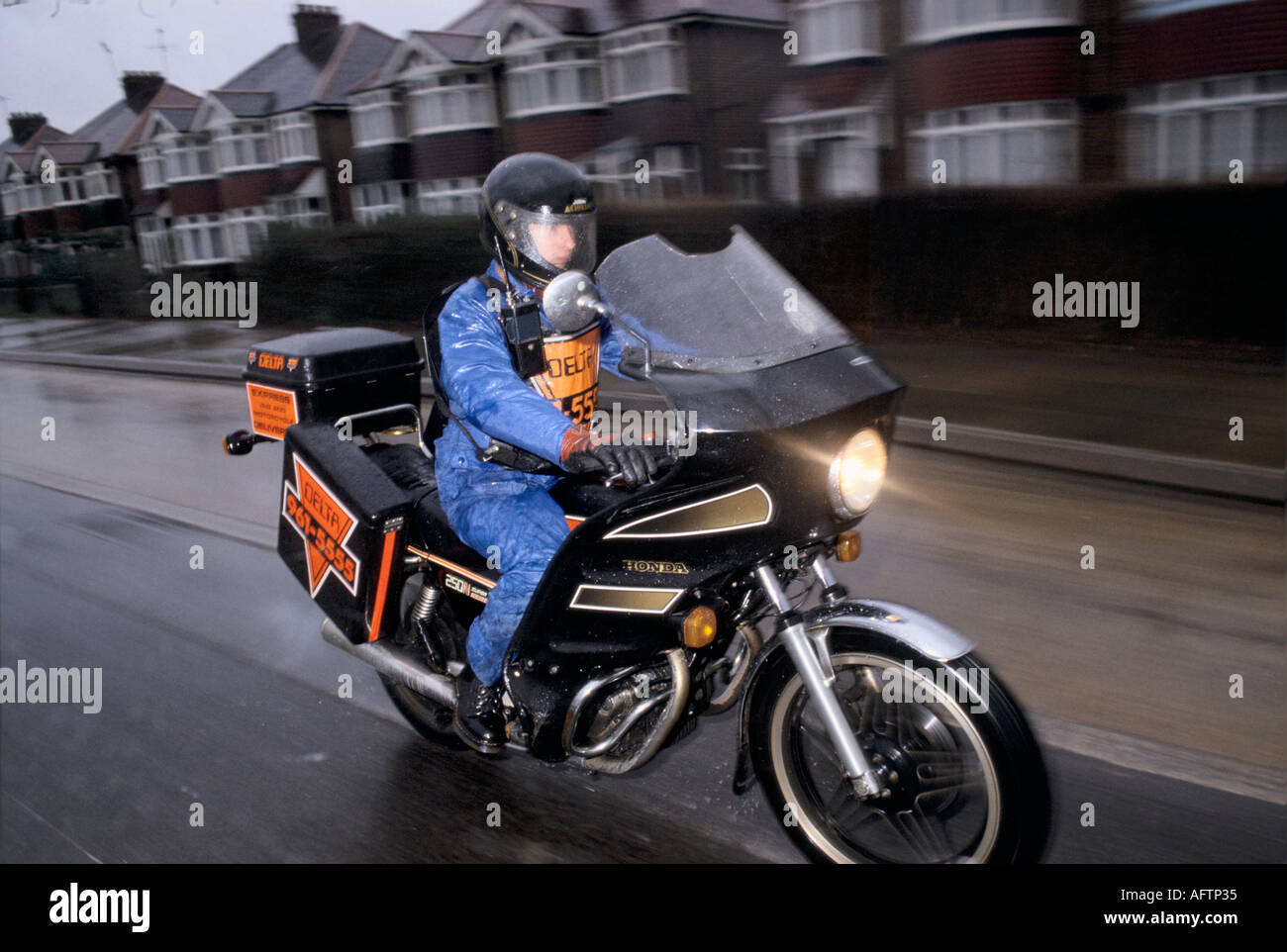 Motorbike courier London delivering letters and small parcel Stock Photo Alamy