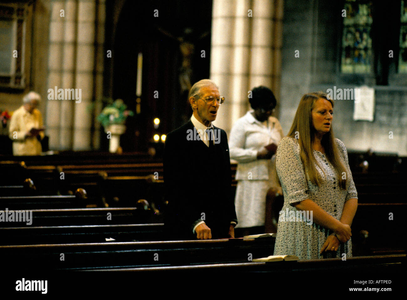 A few parishioners gather in an empty Church of St John the Baptist. High Church of England HOMER SYKES Stock Photo
