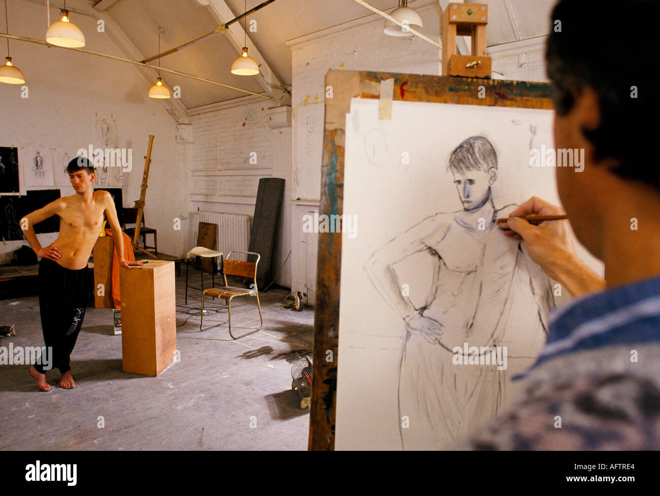 LIfe drawing class, male model artist at work, working on a drawing(01)
