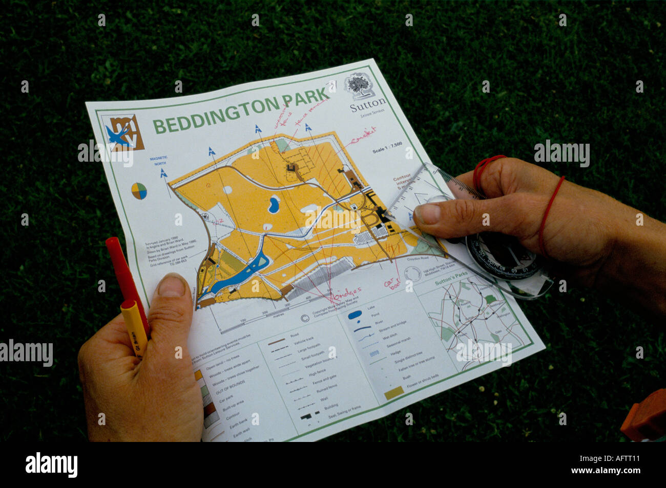 Orienteering Sunday morning meeting hands holding compass map of route in  Beddington Park, near  Croydon Surrey May 1991 1990s UK HOMER SYKES Stock Photo