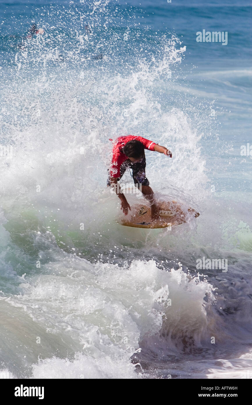 Surfer surfing on breaking wave using a skimboard Stock Photo Alamy