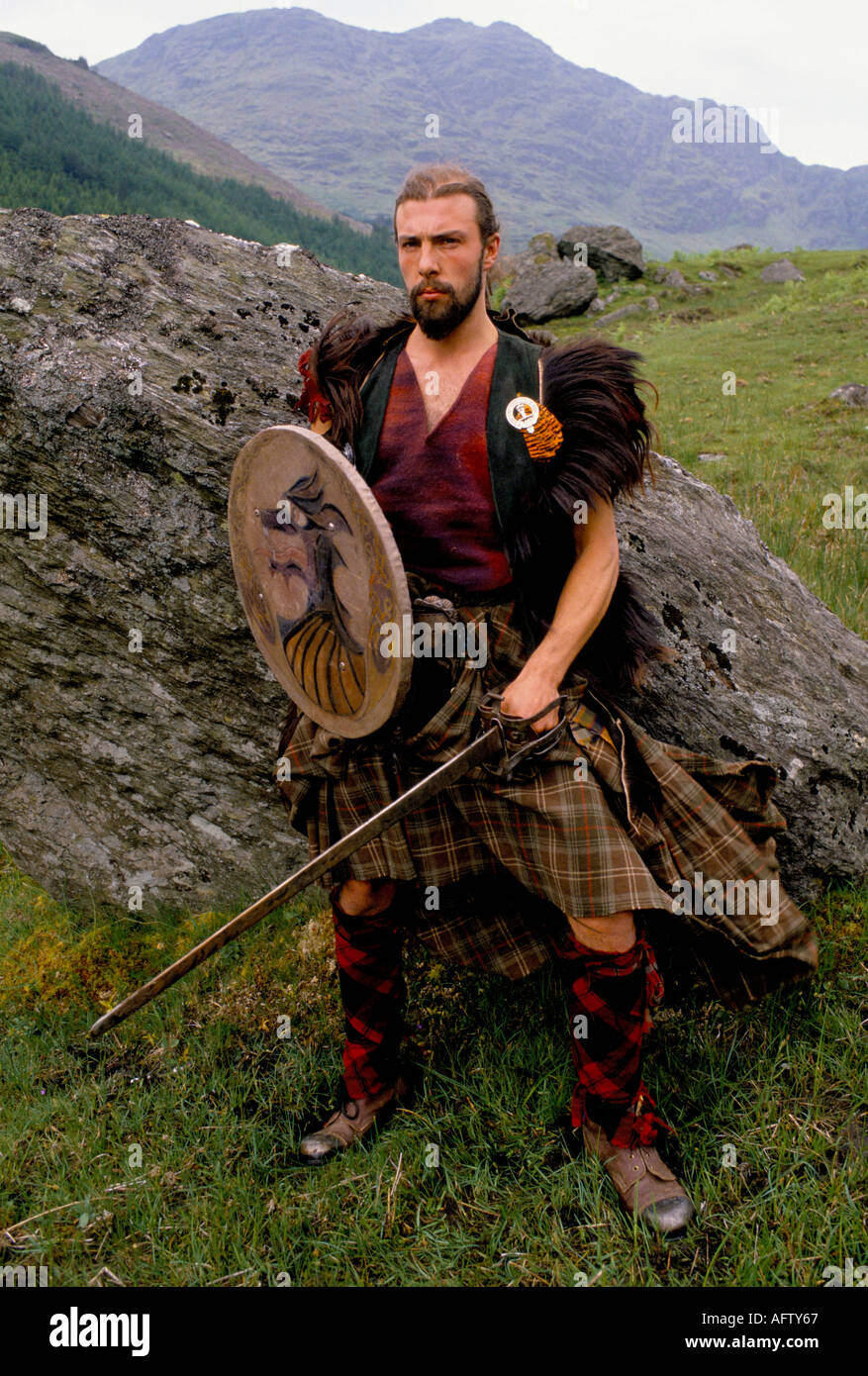 The Clan a Scottish reenactment group dress for the Battle of Culloden a traditional long . Glen Croe Scotland 1990s Uk  HOMER SYKES Stock Photo