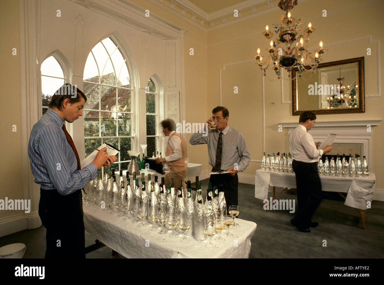 English wine 1980s. Wine tasters judging bottles wrapped up so that wine label cant be seen by judges 1989 Pilton Manor Vineyard Somerset UK. Stock Photo