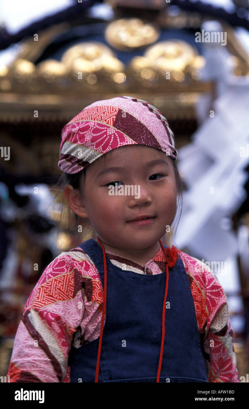 Little Japanese girl in traditional costume during a festival in