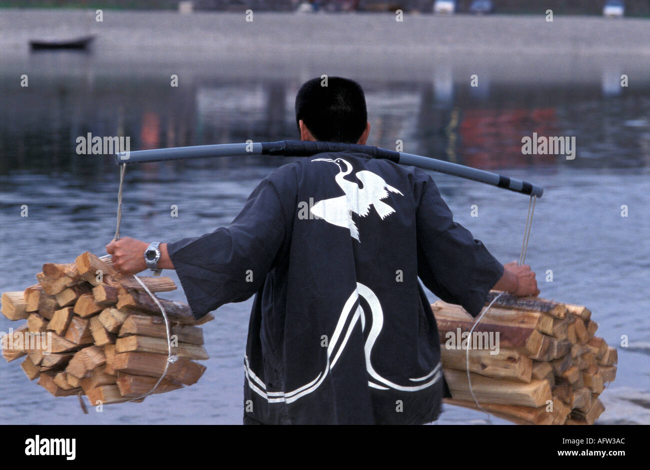Japanese fishermen loading fishing boat with wood for Ukai Stock Photo