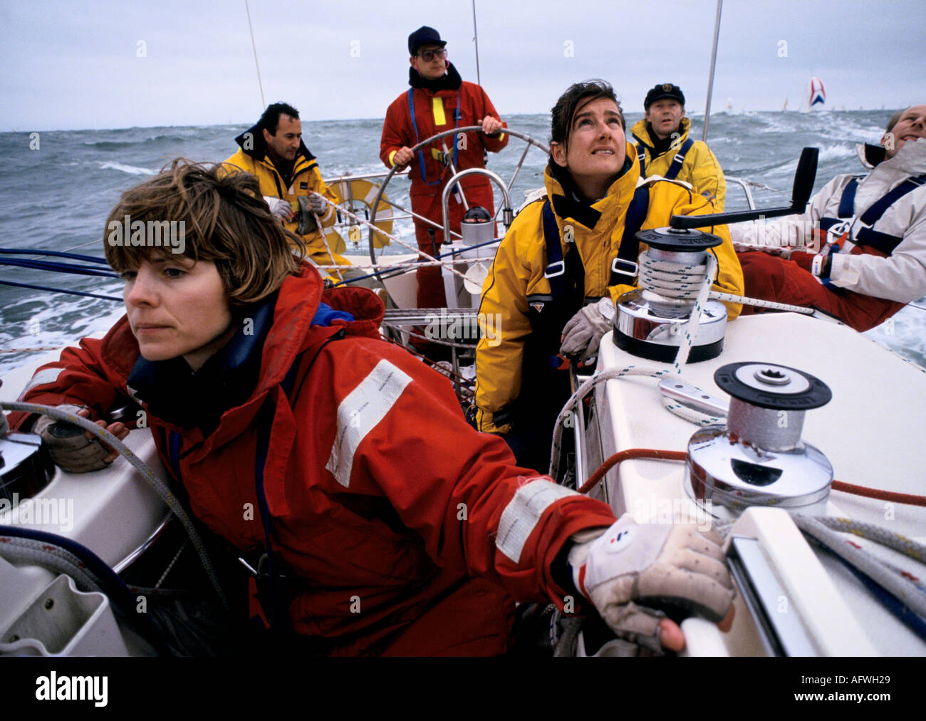Teamwork racing yacht women sailing racing yachts. Crew in The Round the Island Race race the Isle of Wight England 1980s UK HOMER SYKES Stock Photo