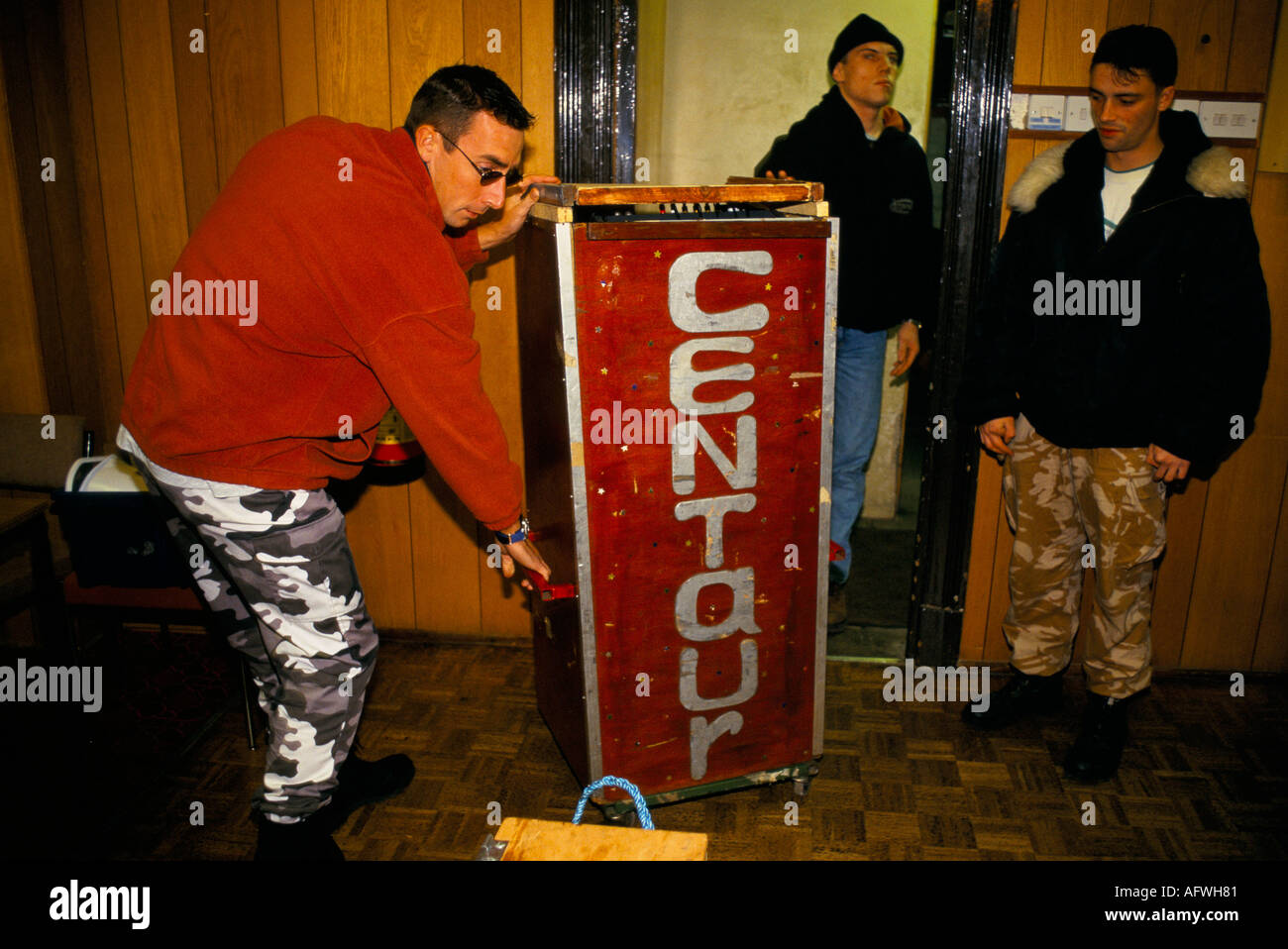 Road crew move equipment into stage area of small club. HOMER SYKES Stock Photo