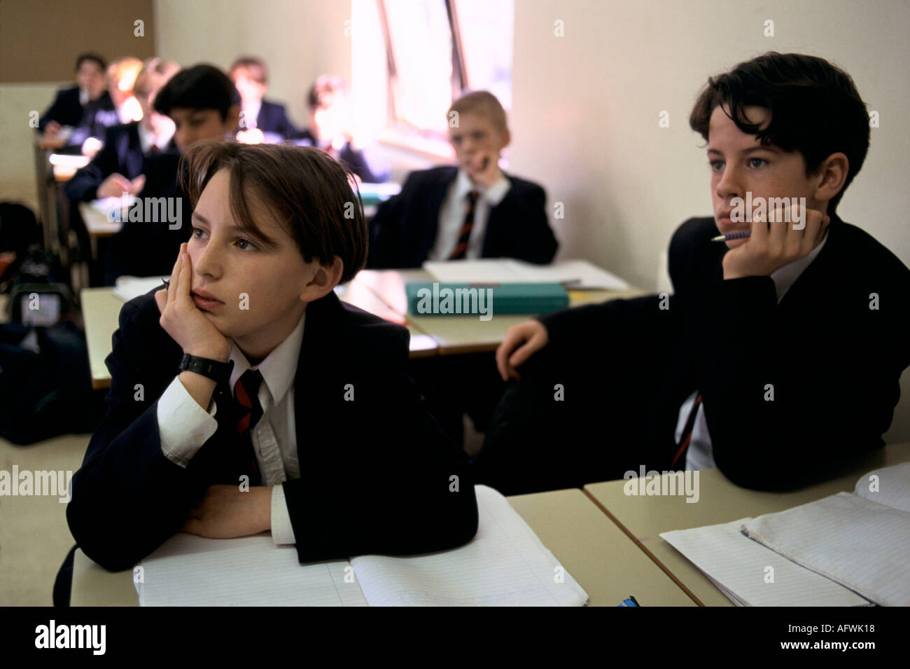 1990s School boy in classroom listening secondary school. Boys are