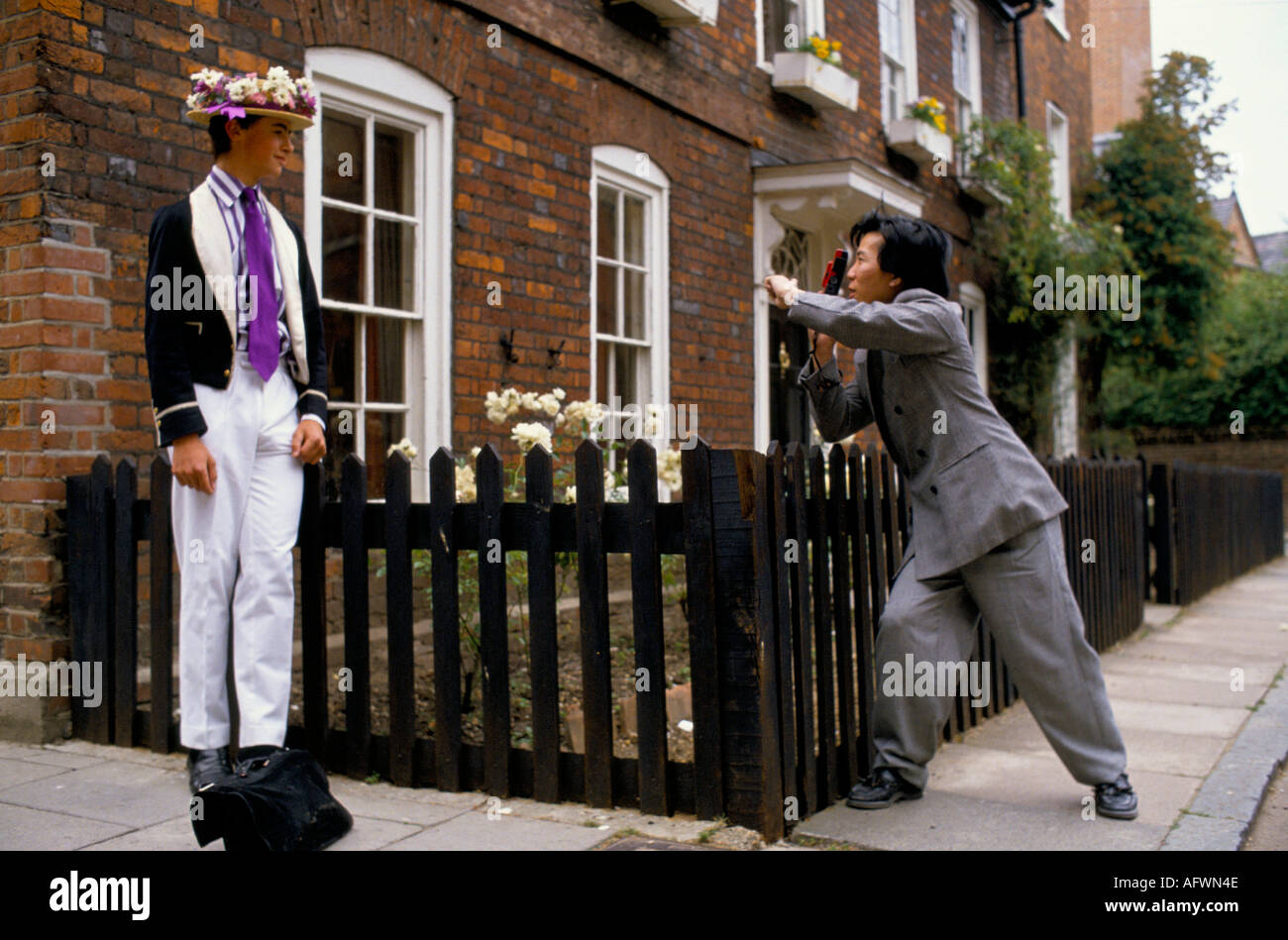 Japanese tourist photographing  Eton schoolboy in naval uniform  dressed for Procession of Boats, Parents Day 4th June 1985 1980 UK Windsor Berkshire Stock Photo