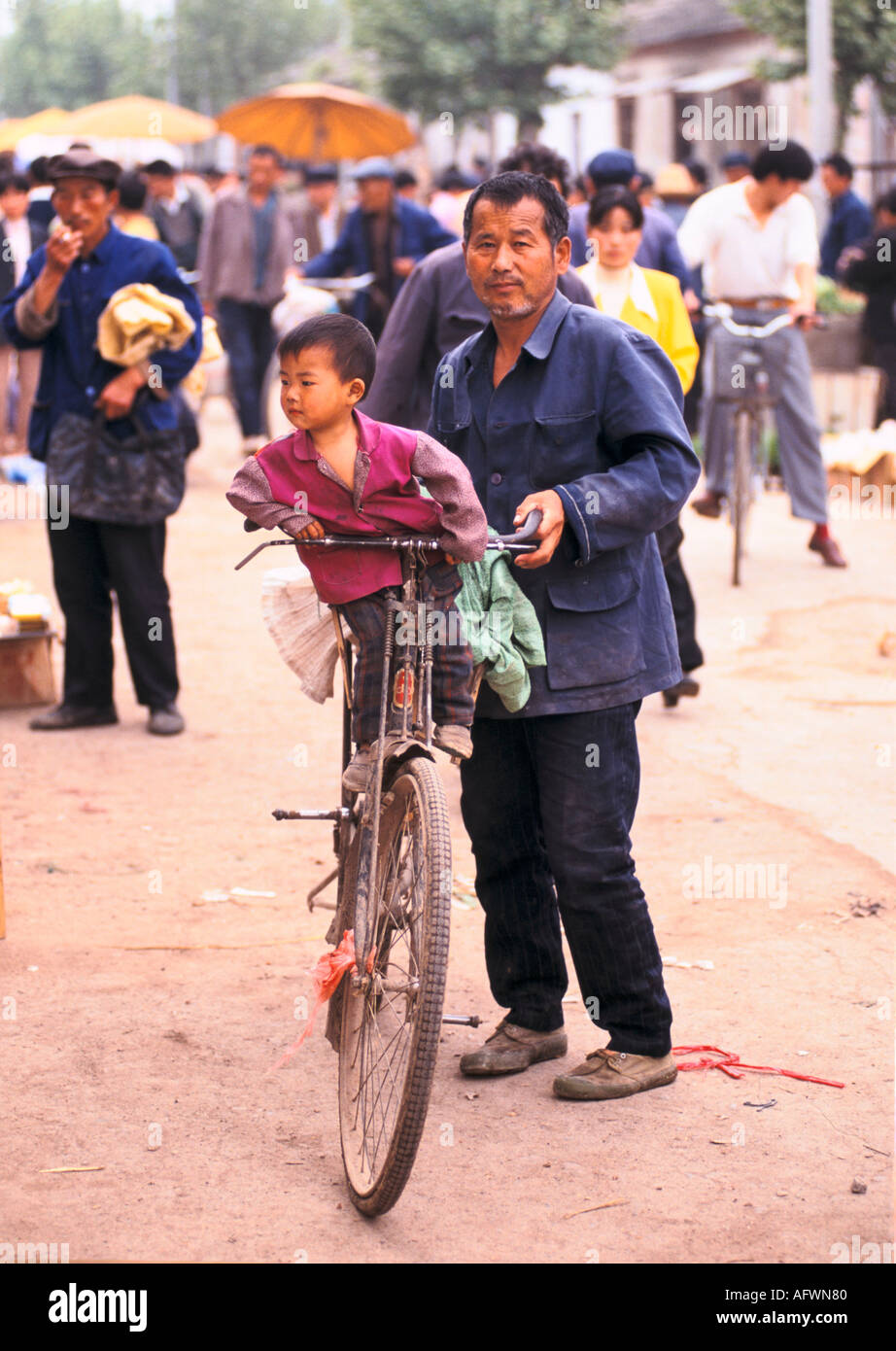 Anhui Province China 1990s. Liufu village rural community father child pedal bike returning from market. Chinese One Child Policy 1998 HOMER SYKES Stock Photo