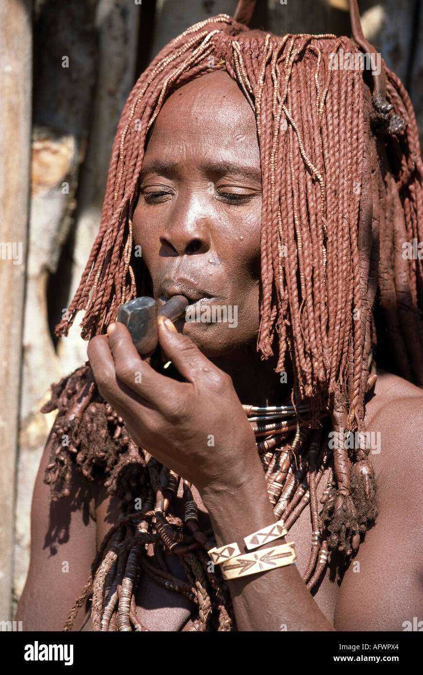 people, women, Namibia, Himba woman smoking a pipe, portrait, Additional-Rights-Clearance-Info-Not-Available Stock Photo