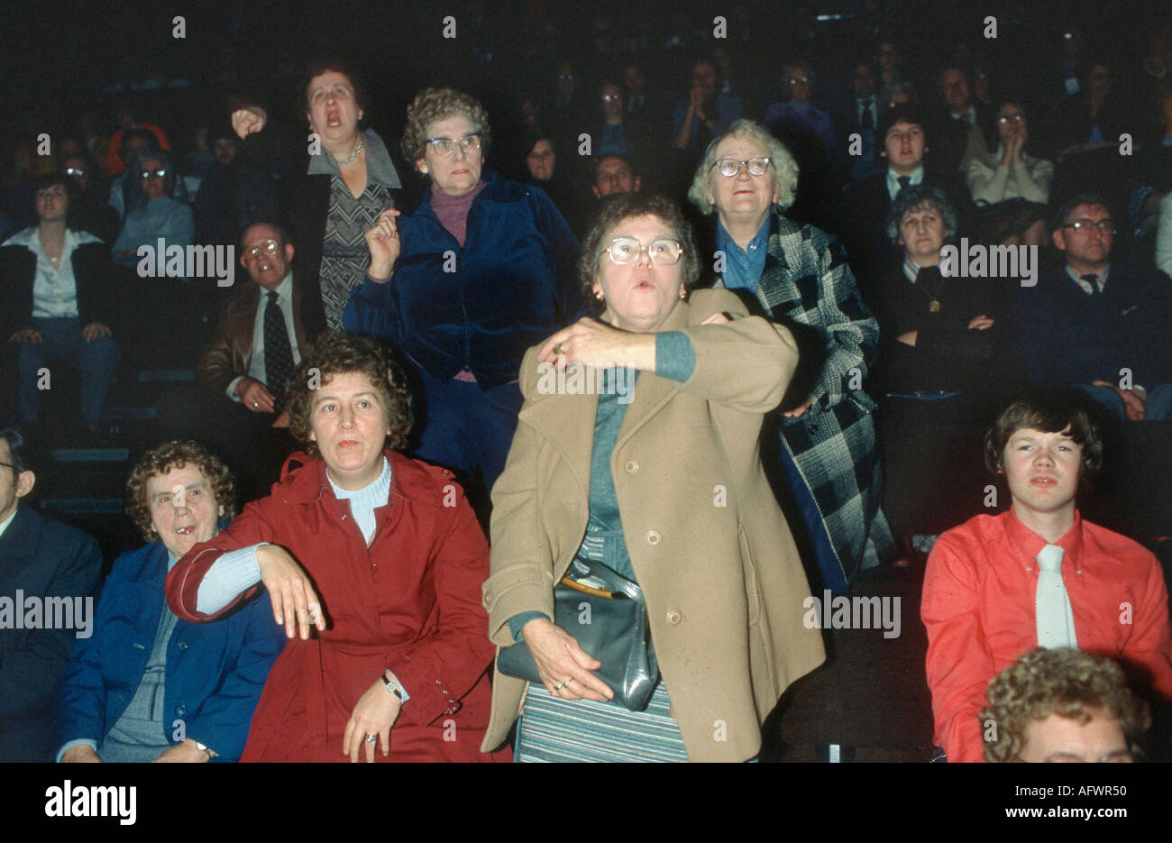 Middle aged women cheering on their man at an All in Wrestling match.  Booing the opponent. The Assembly Rooms, Derby Derbyshire 1980  HOMER SYKES Stock Photo