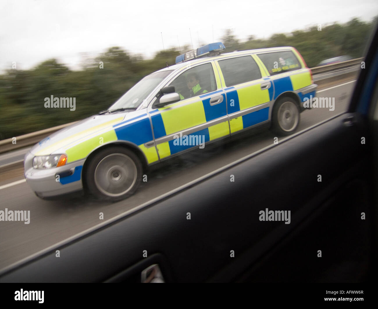 Police car overtaking on a motorway, Are they checking me out Should I pull over? Stock Photo