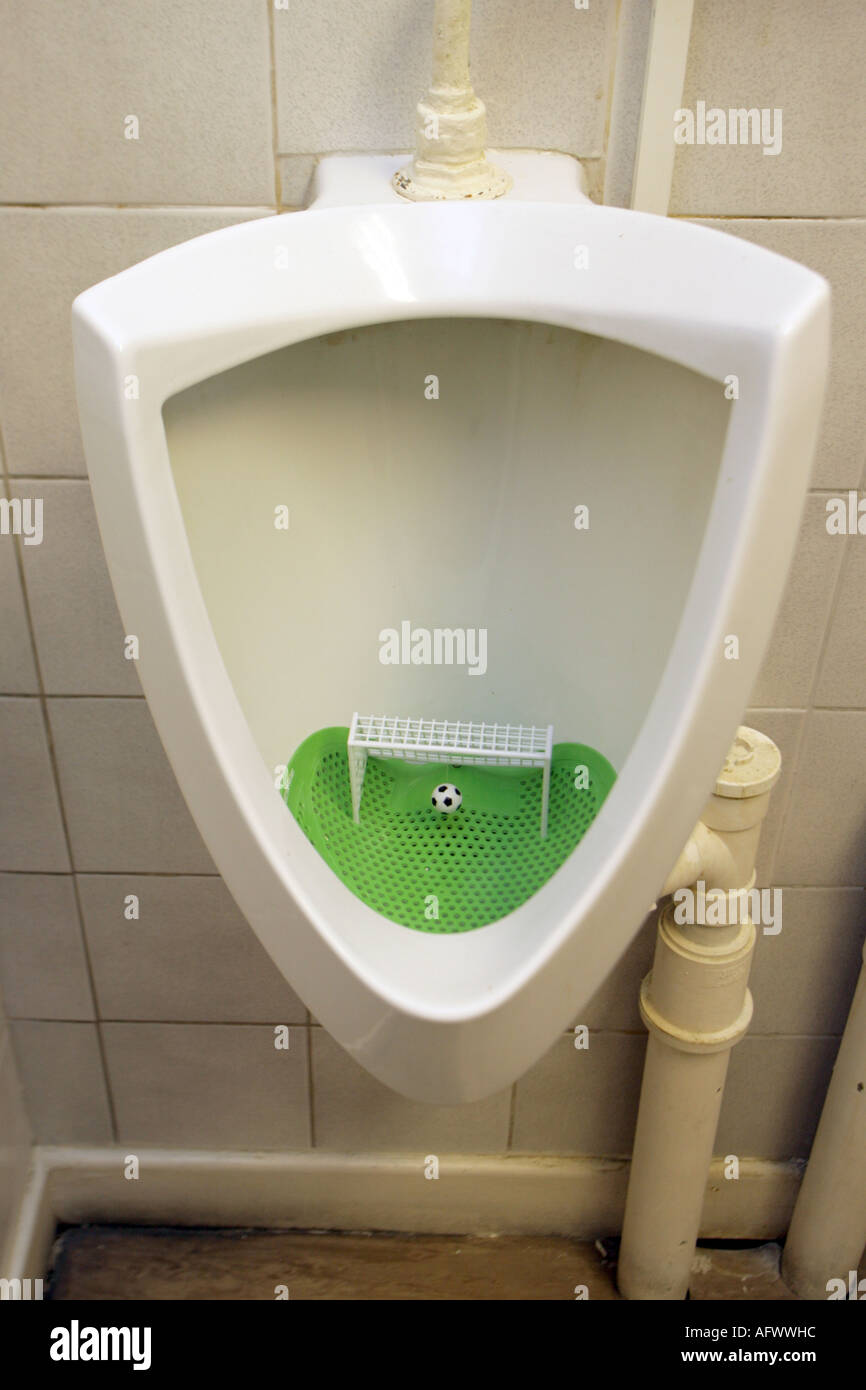 urinal with goal and football to help the aim. in a social club