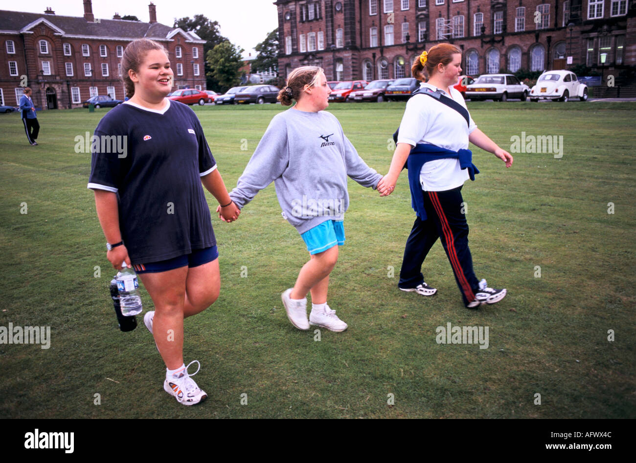 Teenage girls, overweight kids bonding at a  summer camp for obese teenagers. Leeds, Yorkshire England 1999 1990s UK HOMER SYKES Stock Photo