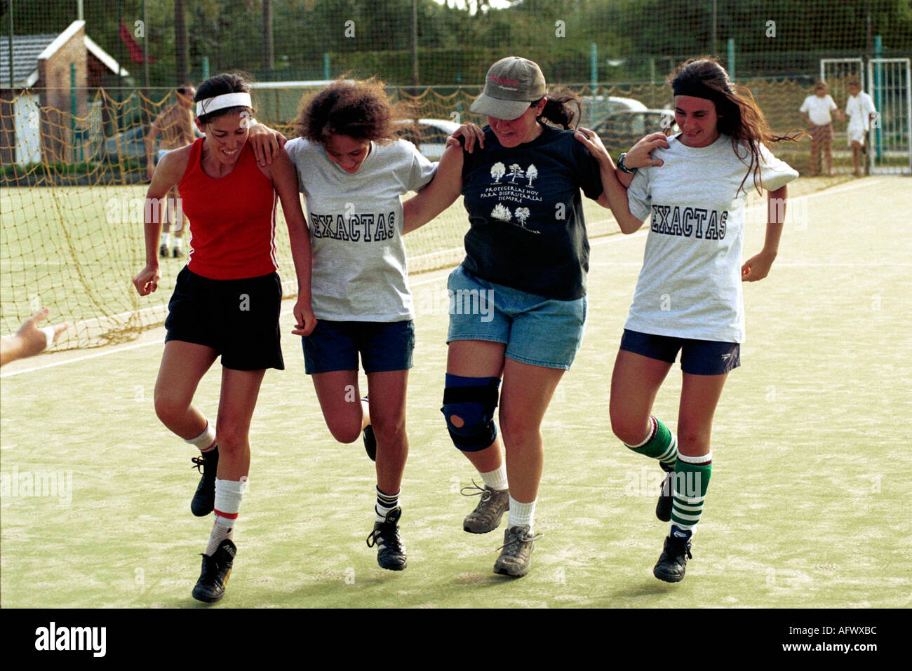 Argentina women playing football 2002, The Exactas soccer all womens team practice, girls helping injured team member Buenos Aires 2000s HOMER SYKES Stock Photo