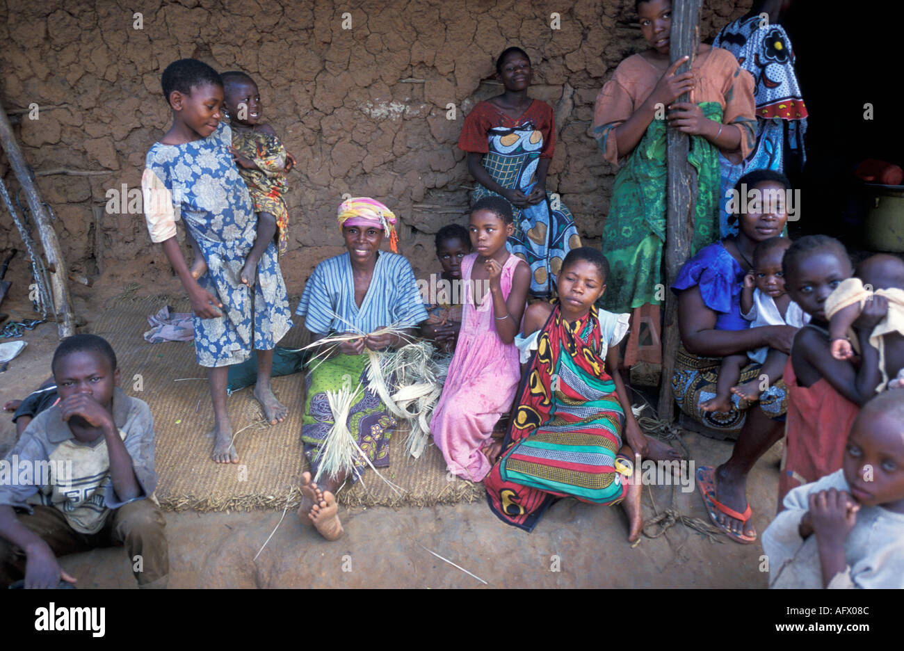 AFRICA KENYA KWALI Kenyan grandmother making straw mat on the porch of