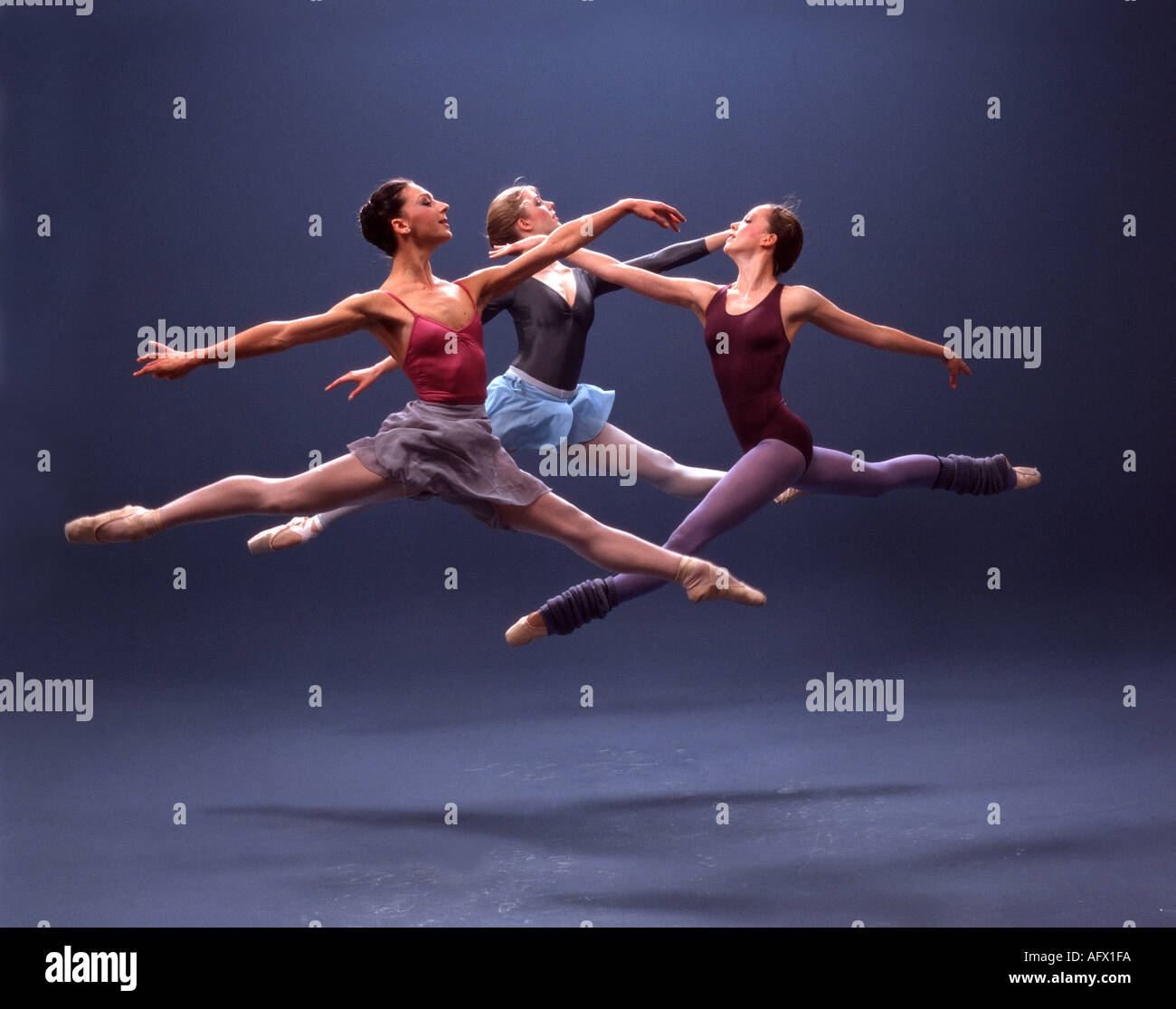 The women ballet dancers execute a simultaneous grand jete Stock Photo