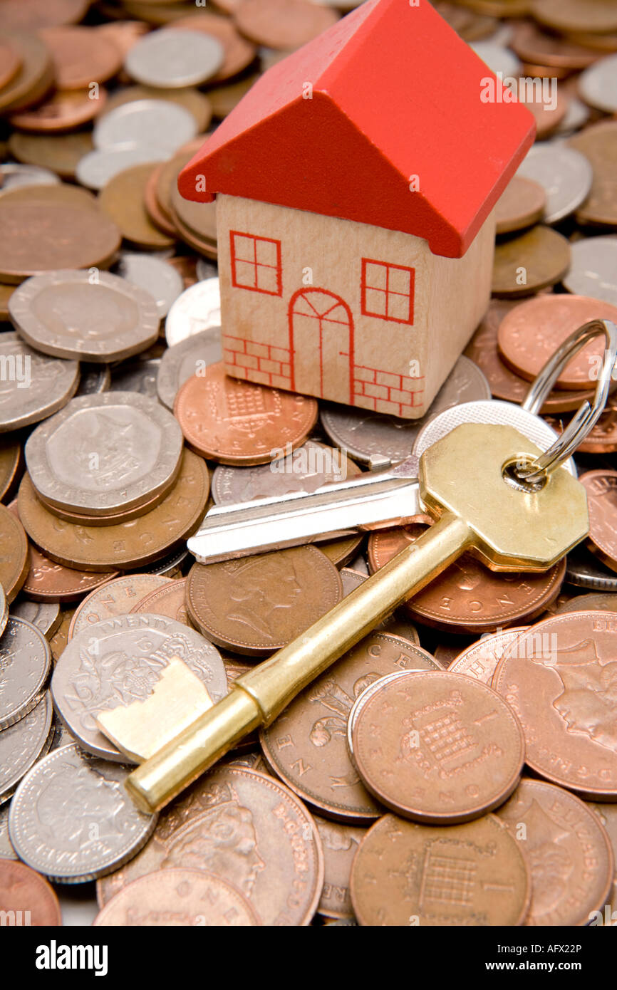 Financial investment in UK property market house keys and cash for investing in a new house or property Stock Photo