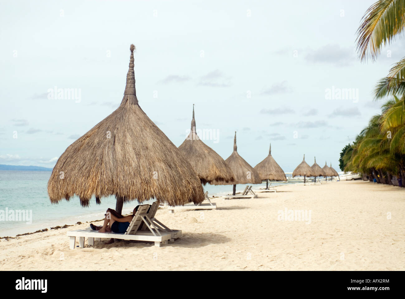 Philippines People Relaxing Under Thatched Beach Umbrellas Bohol Beach Club Alona Visayas Photo - Alamy