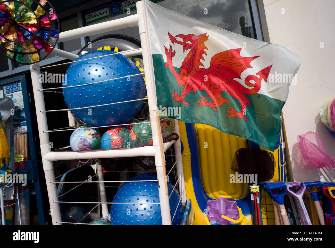 welsh flag banner and plastic beach goods for sale outside shop Stock Photo