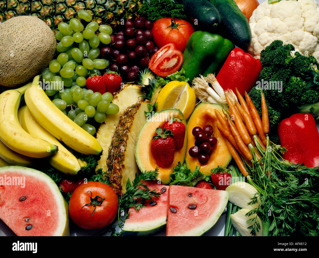 variety of fruit and vegetables spread out on table food Stock Photo