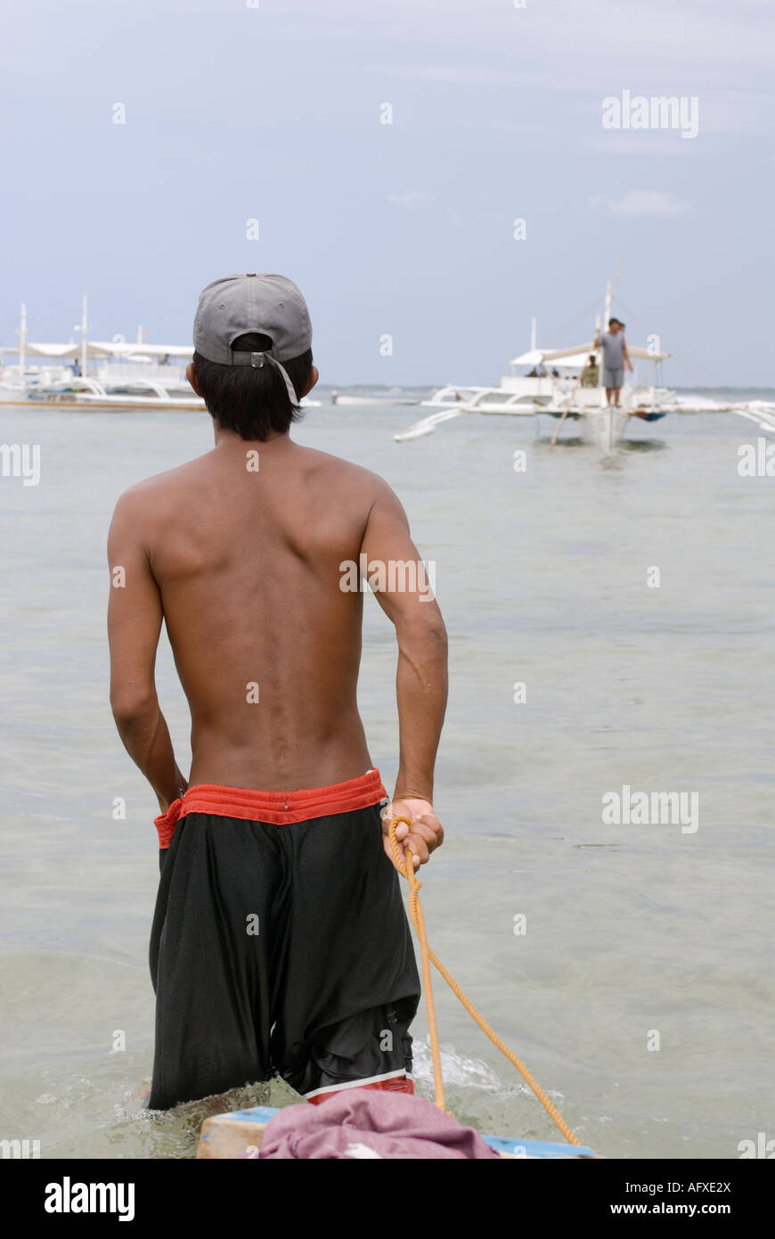 Philippines Young Filipino Man Pulling Dingy Boat Cebu Island Visayas Stock Photo