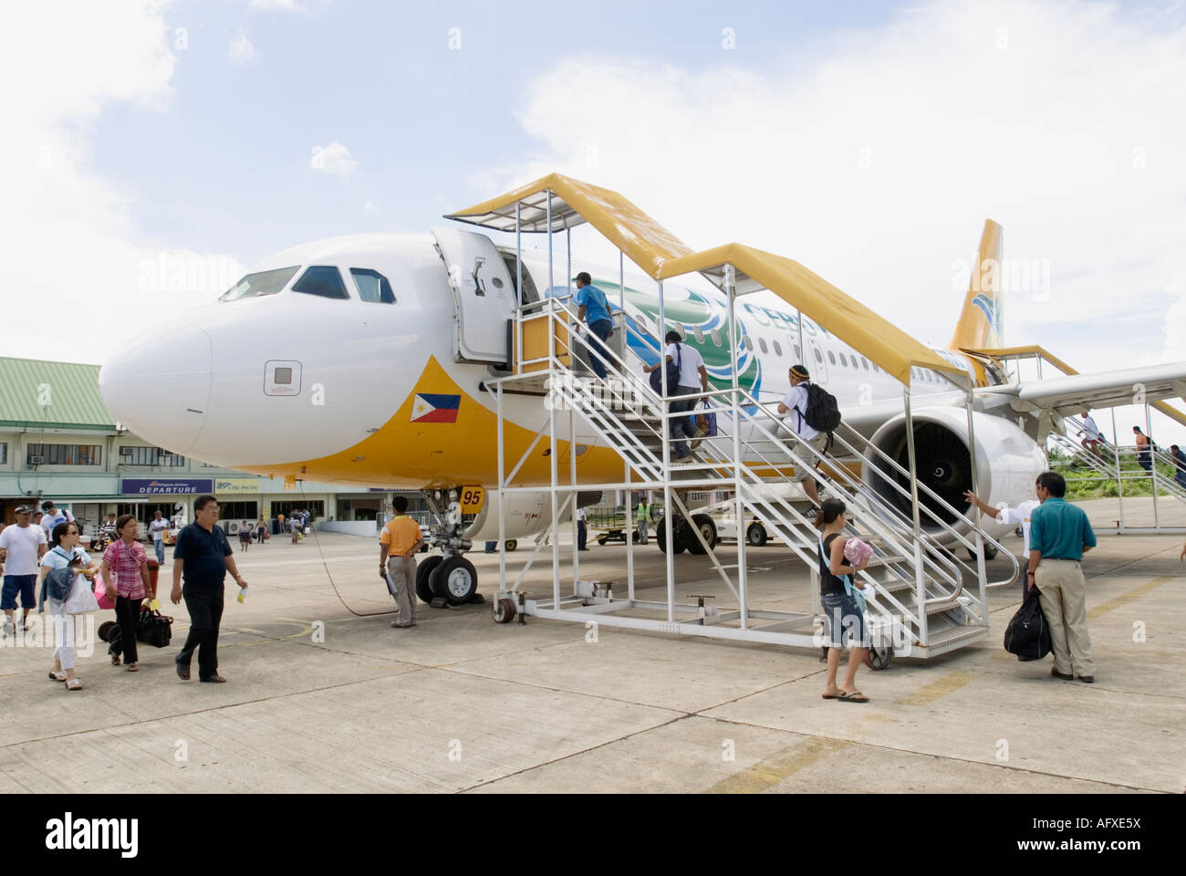 Passengers Walking On Tarmac And Boarding Cebu Pacific Airplane
