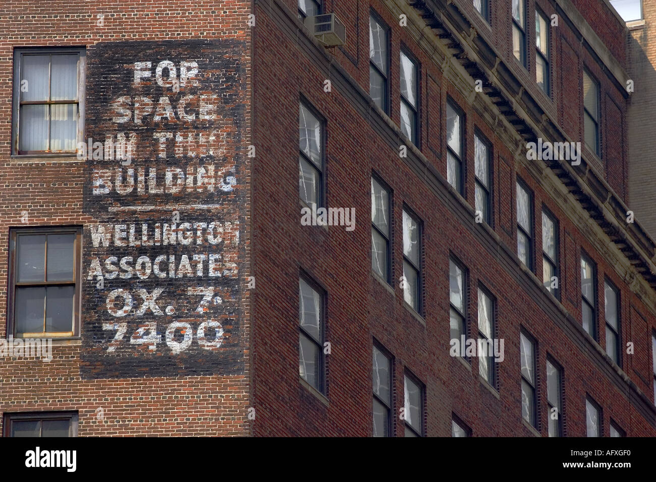 A fading sign offers space for rent in an older office building in the ...