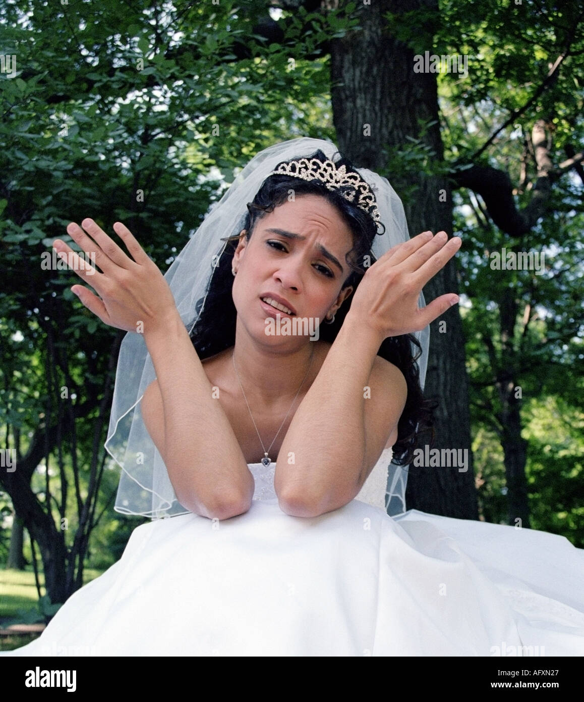 upset and angry bride throws up her hands in despair wearing her