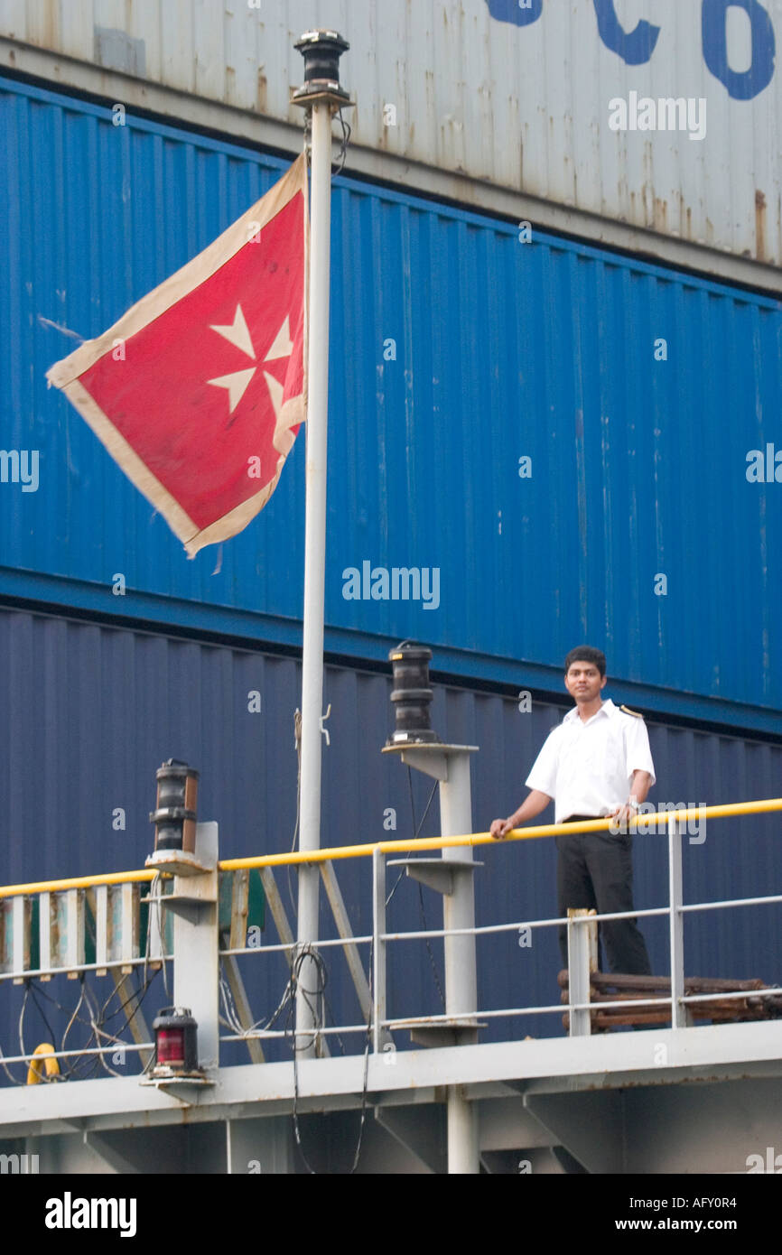Ship cadet stands on the stern of container ship with flag on monrovia Stock Photo
